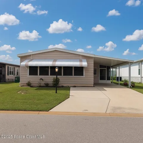 a front view of a house with a garden and yard