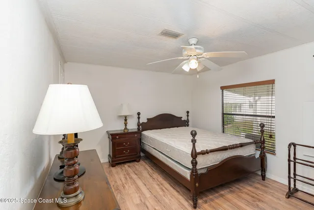 a bedroom with a bed and a lamp