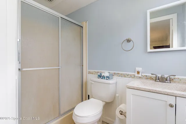a bathroom with a sink a toilet and vanity