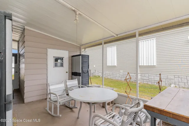 a view of a dining room with furniture and a window