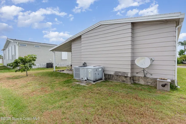 a view of a backyard with a garden and entertaining space