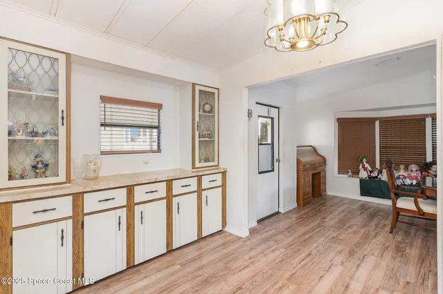a kitchen with cabinets and wooden floor