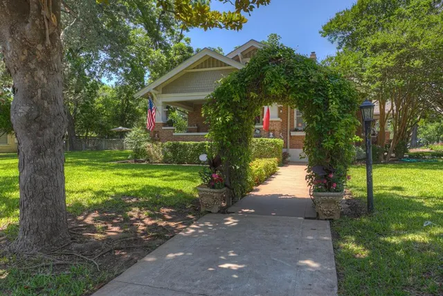 a front view of a house with garden