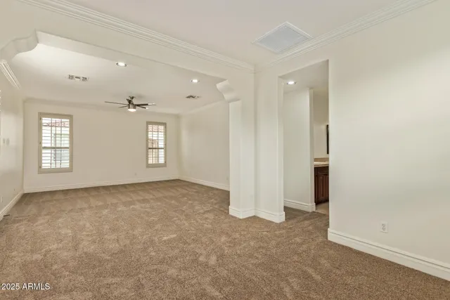 an empty room with windows and closet