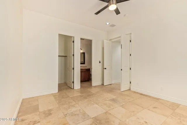 an empty room with a ceiling fan