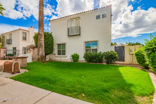 a view of a house with backyard and a tree