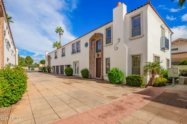 a front view of a building with potted plants