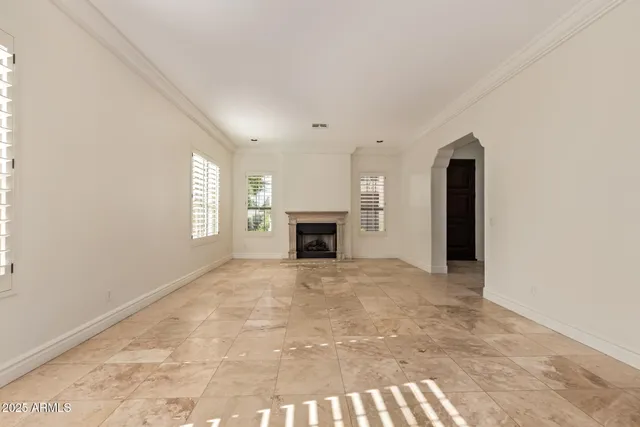 a view of empty room with window and fireplace
