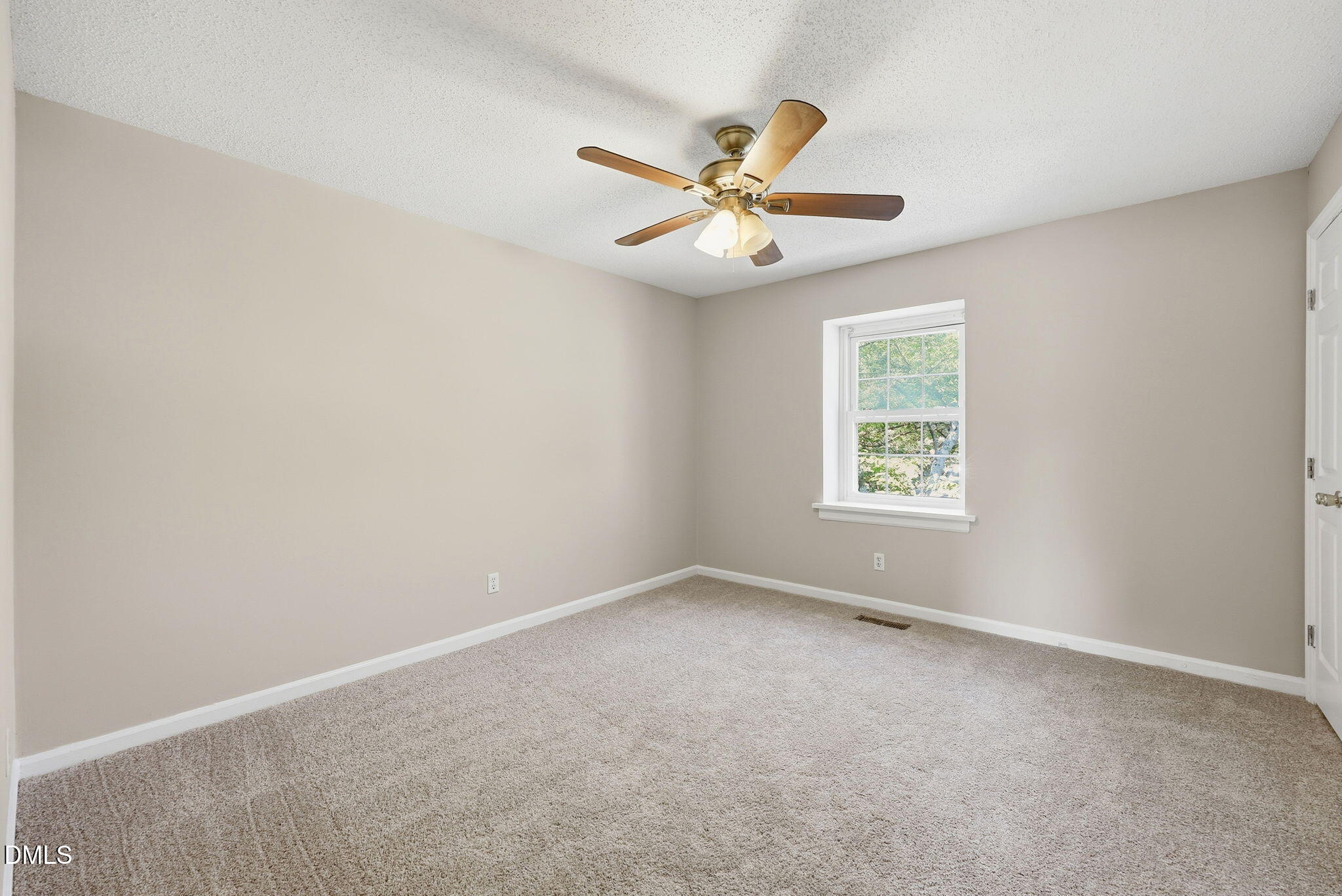 145 Jones Franklin Road, Unit D Raleigh, NC 27606 - Photo 10 of 23 an empty room with a window and a fan