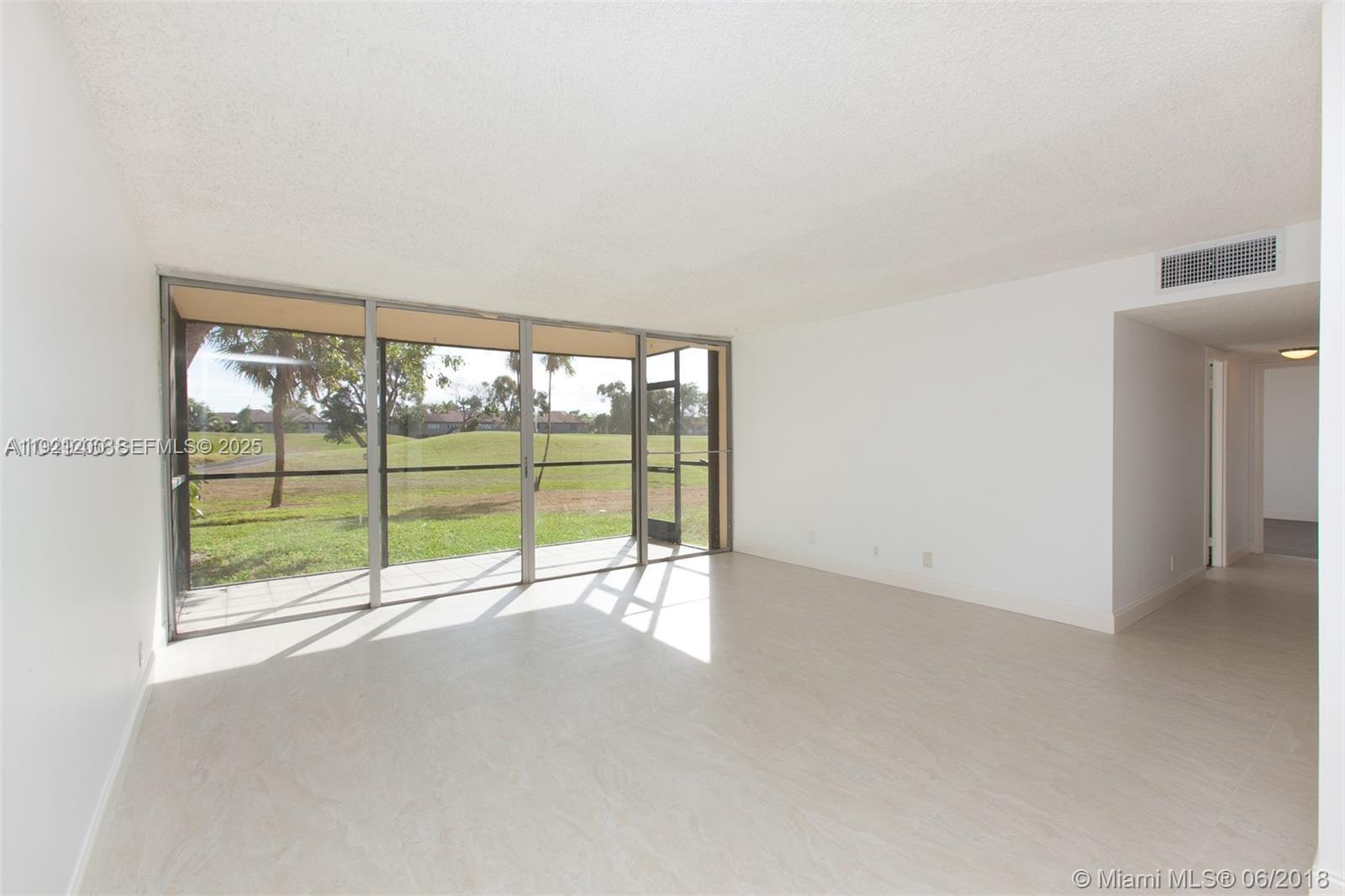 3821 Environ Boulevard, Unit 107 Lauderhill, FL 33319 - Photo 5 of 19 a view of an empty room with a large window
