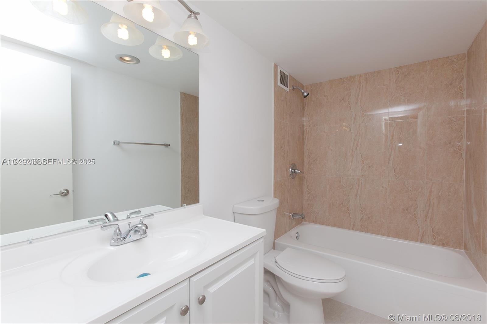 3821 Environ Boulevard, Unit 107 Lauderhill, FL 33319 - Photo 7 of 19 a bathroom with a sink a toilet and shower