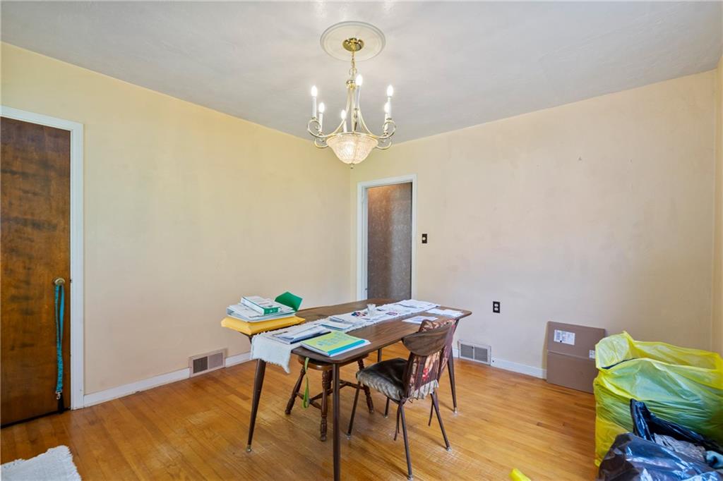 53 Lawrence Street Pittsburgh, PA 15209 - Photo 11 of 36 a view of a dining room with furniture and wooden floor