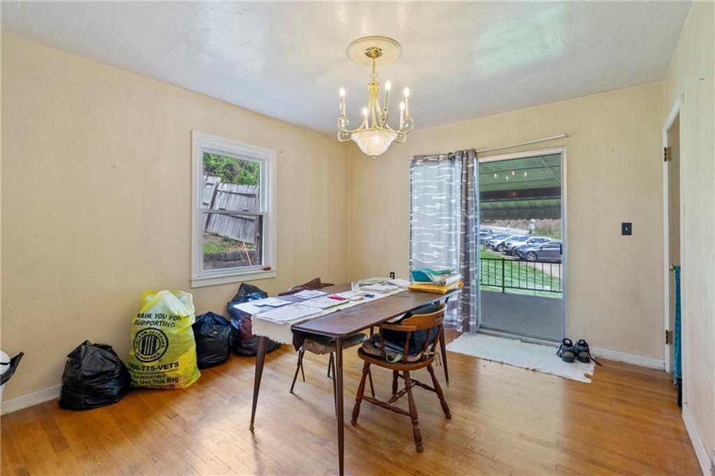 53 Lawrence Street Pittsburgh, PA 15209 - Photo 12 of 36 a livingroom with dining area a chandelier and window