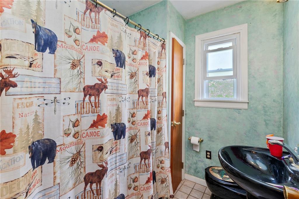 53 Lawrence Street Pittsburgh, PA 15209 - Photo 15 of 36 a bathroom with a sink and a shower curtain