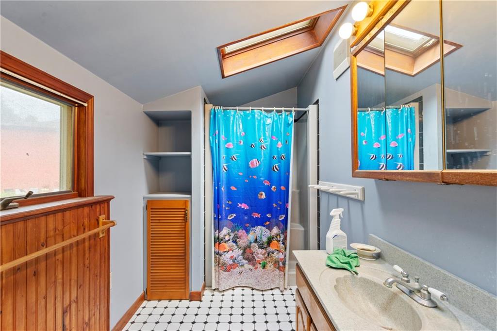 53 Lawrence Street Pittsburgh, PA 15209 - Photo 21 of 36 a bathroom with a sink a mirror and next to a window