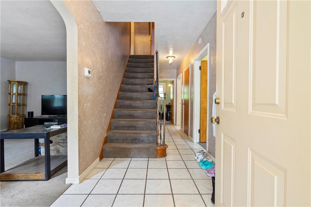 53 Lawrence Street Pittsburgh, PA 15209 - Photo 4 of 36 a view of a hallway with wooden floor and staircase