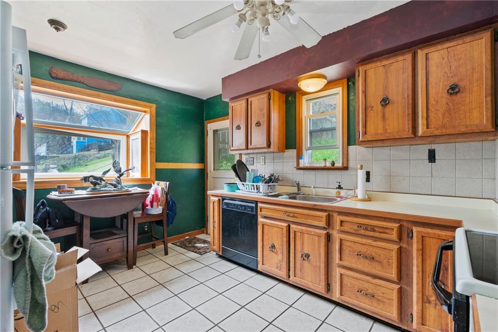 53 Lawrence Street Pittsburgh, PA 15209 - Photo 7 of 36 a kitchen with stainless steel appliances a sink and cabinets
