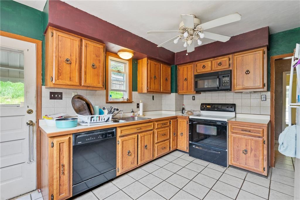 53 Lawrence Street Pittsburgh, PA 15209 - Photo 10 of 36 a kitchen with stainless steel appliances granite countertop a stove sink and cabinets