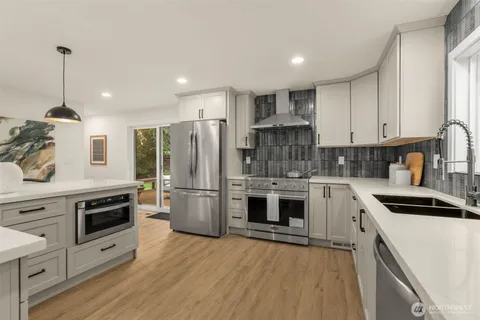 a kitchen with a stove a sink and a refrigerator