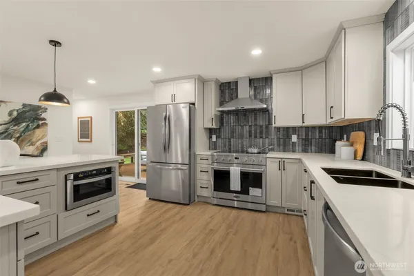 a kitchen with a stove a sink and a refrigerator