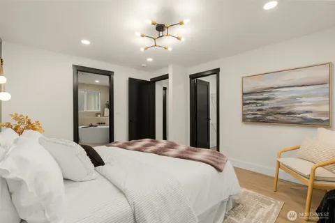 a bedroom with a bed and a chandelier