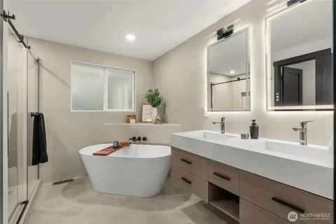 a bathroom with a bathtub and double sink
