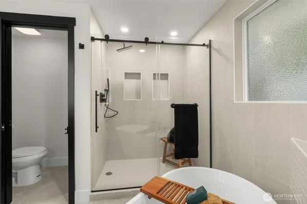 a bathroom with a shower a toilet and a shower