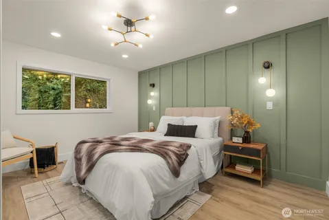 a bedroom with a bed and a chandelier