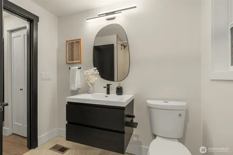 a bathroom with a toilet sink and mirror