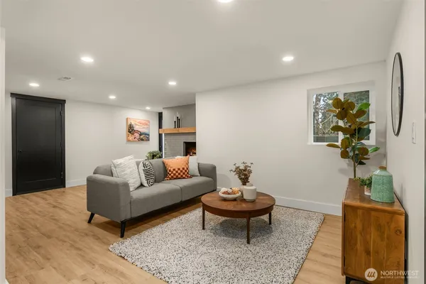 a living room with furniture and a potted plant