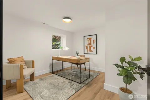 a workspace with furniture and a potted plant