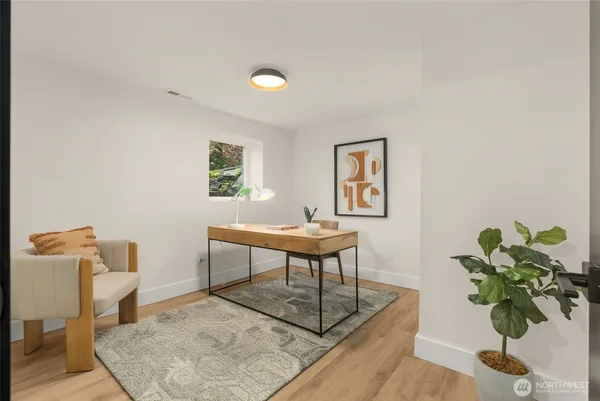 a workspace with furniture and a potted plant