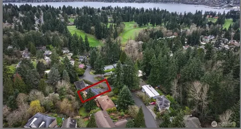 an aerial view of lake and residential houses with outdoor space