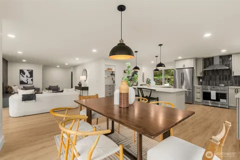 a dining room with furniture a window and kitchen view