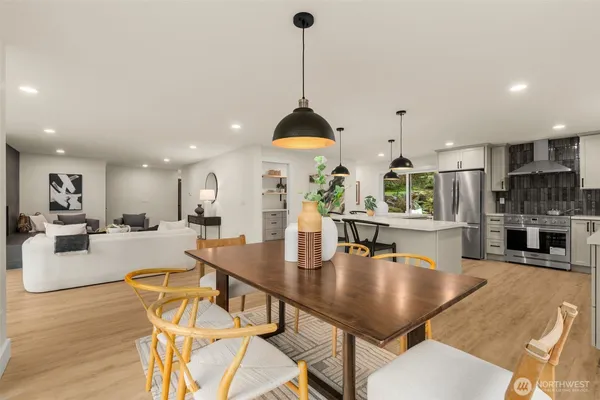 a dining room with furniture a window and kitchen view