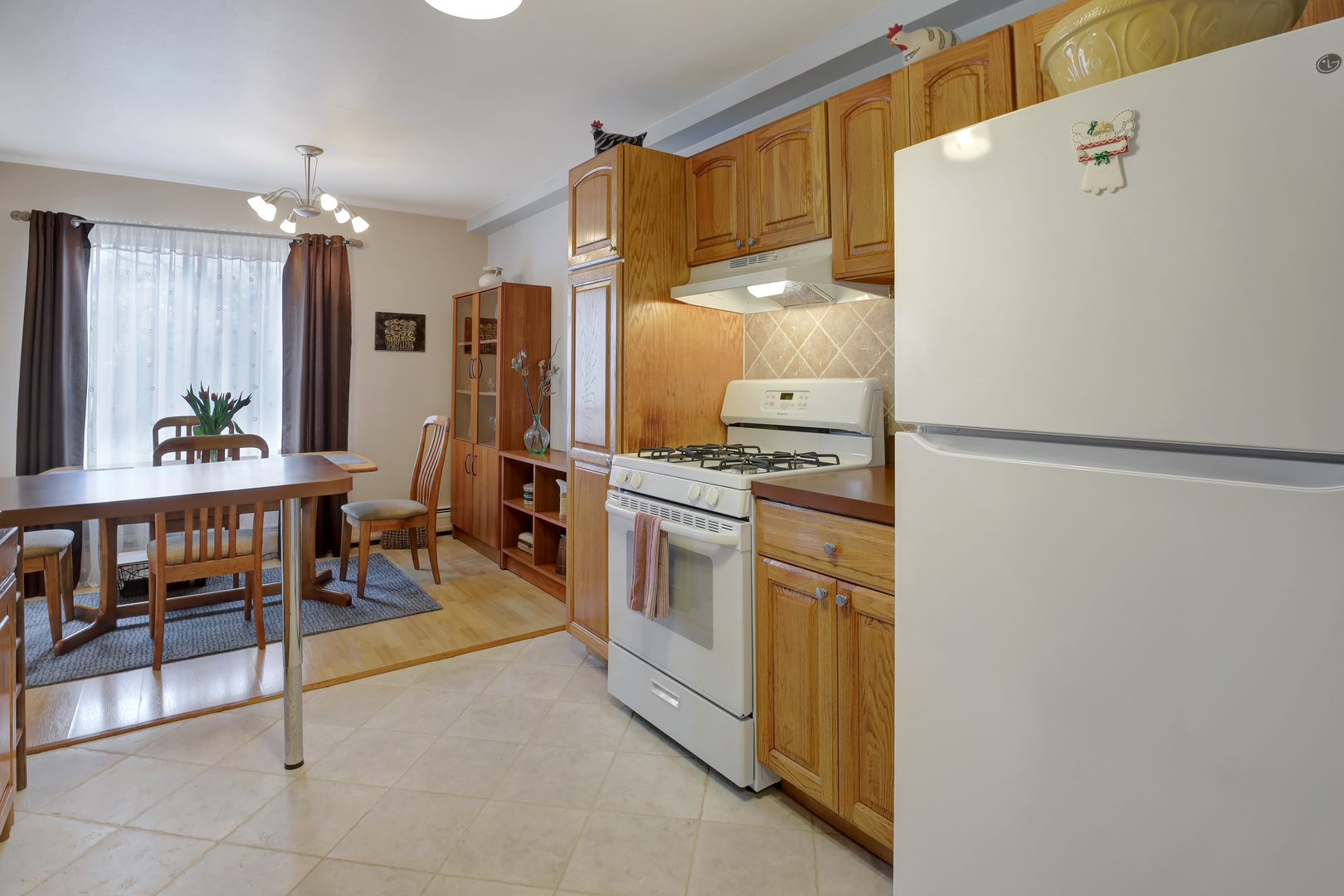 950 East Old Willow Road, Unit 102 Prospect Heights, IL 60070 - Photo 5 of 27 a kitchen with stainless steel appliances a refrigerator and a table