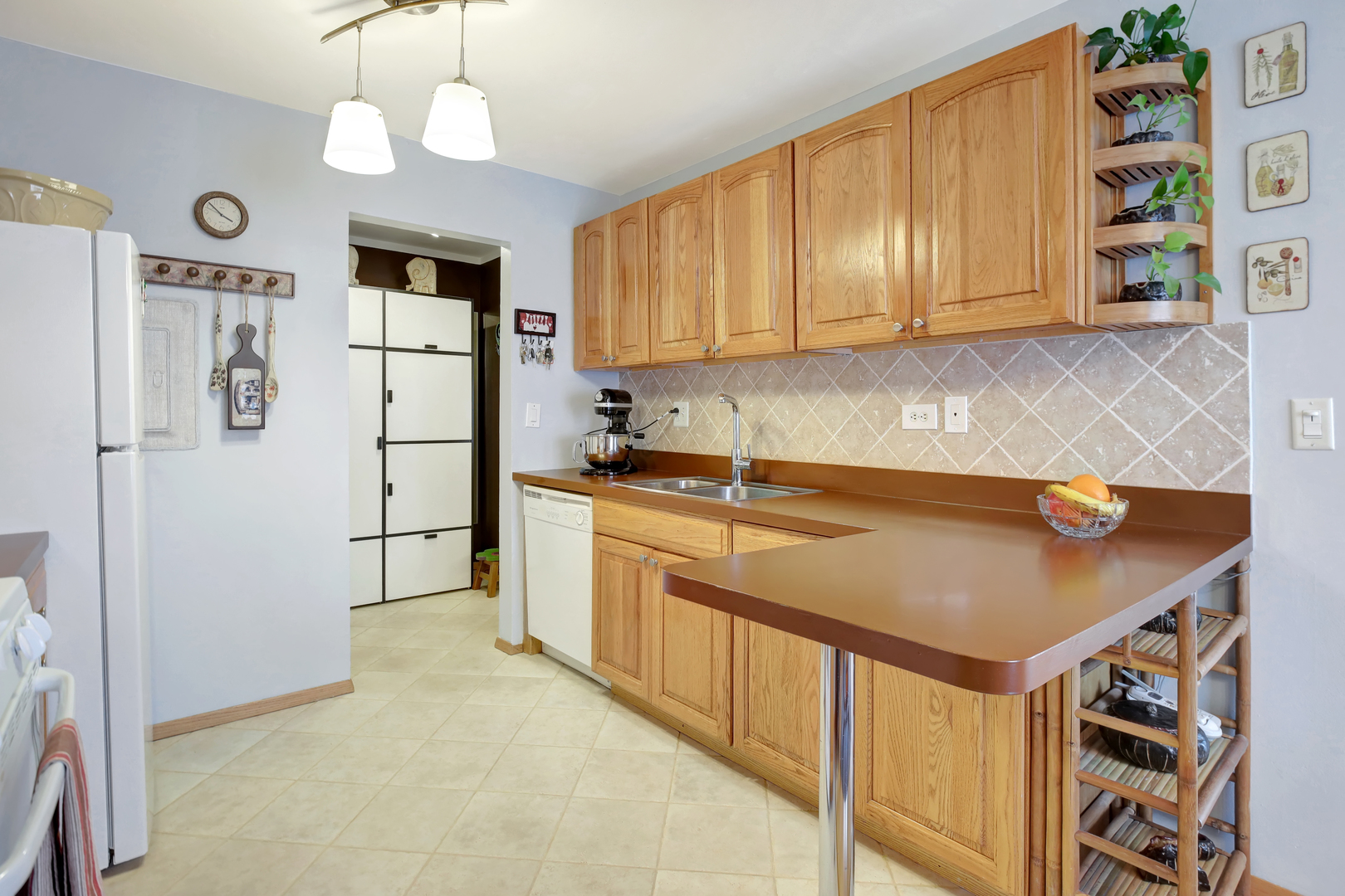 950 East Old Willow Road, Unit 102 Prospect Heights, IL 60070 - Photo 6 of 27 a kitchen with stainless steel appliances granite countertop a refrigerator a sink dishwasher a dining table and chairs with wooden floor