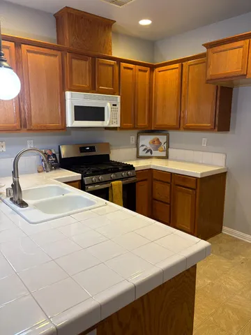 a kitchen with stainless steel appliances a sink stove and microwave