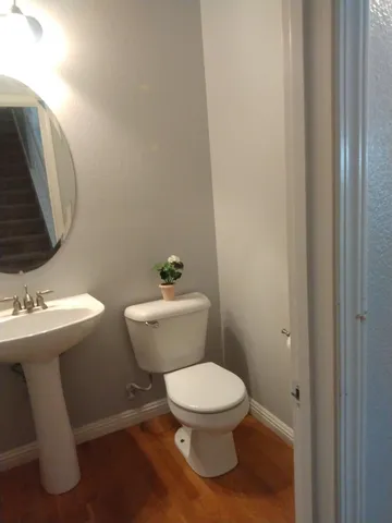a bathroom with a toilet a sink and mirror
