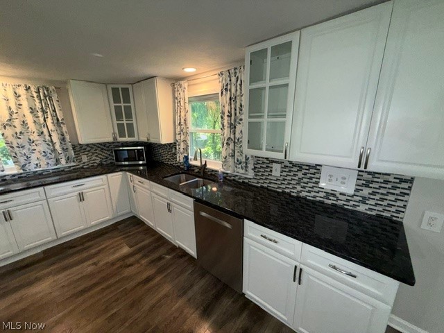 1087 Krumroy Road Akron, OH 44306 - Photo 11 of 38 Kitchen featuring white cabinetry, dark stone countertops, mosaic tile backsplash, stainless steel sink, and wood-finish flooring