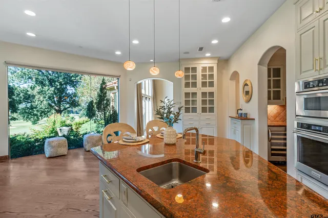 a kitchen with furniture and a large window