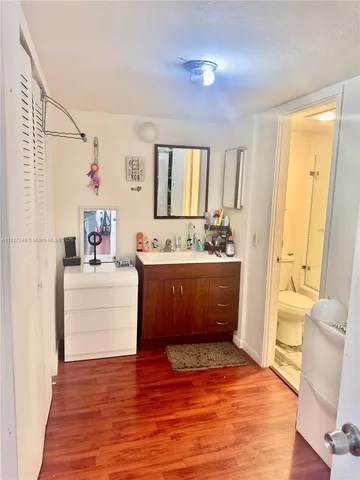 a bathroom with a tub sink and mirror