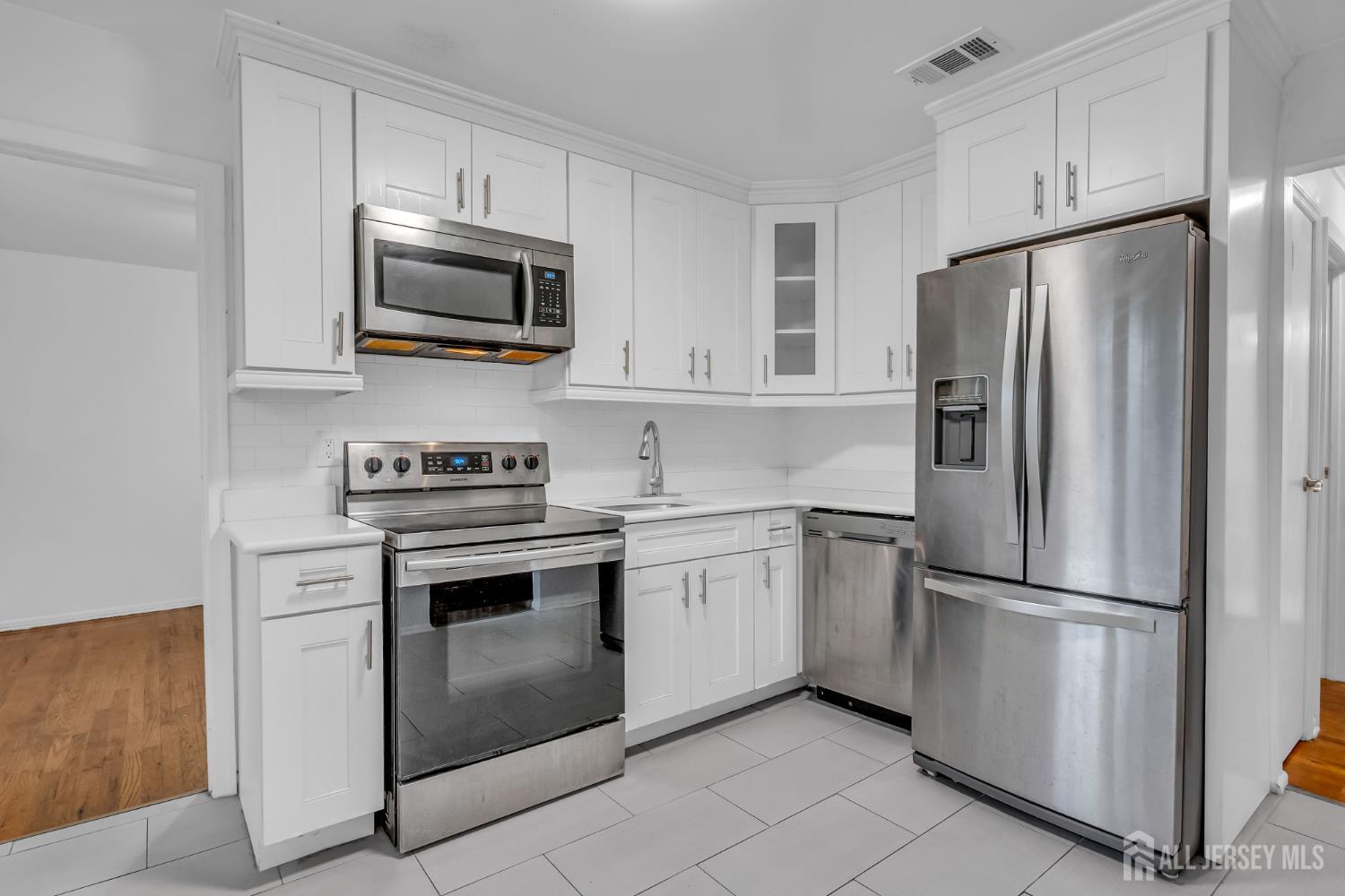 14 College Drive Edison, NJ 08817 - Photo 19 of 22 a kitchen with stainless steel appliances white cabinets white and a stainless steel appliances