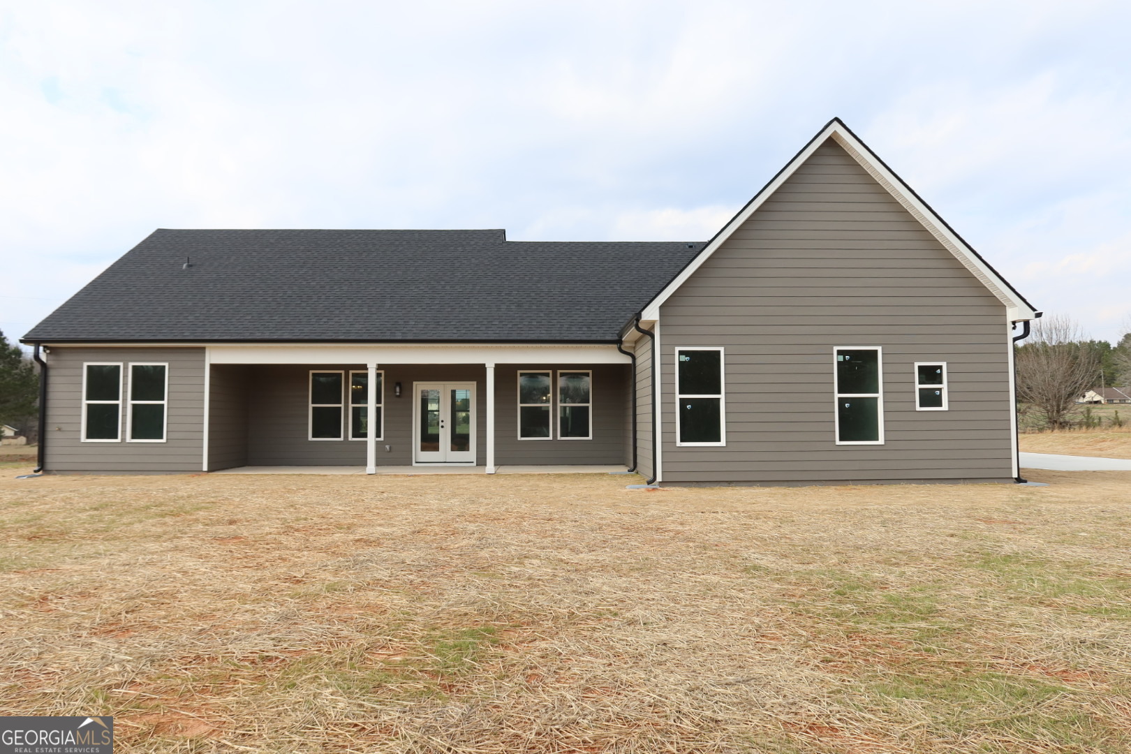 1205 Rocky Creek Road Hampton, GA 30228 - Photo 6 of 9 a front view of house with yard and trees around