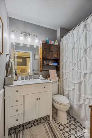 a bedroom with a large bed and a window