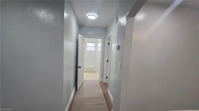 a room with wooden floor and windows