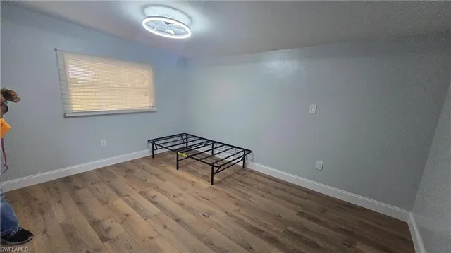 a large white room with furniture and a mirror