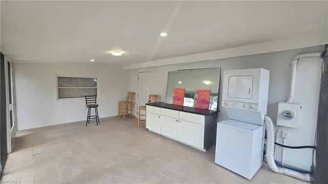 a view of a house with backyard and a tree