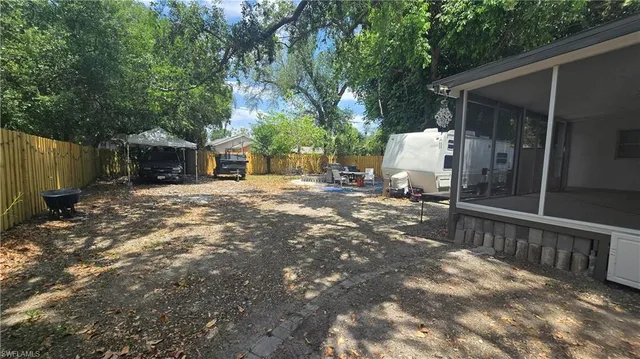 a front view of a house with a yard and tree s