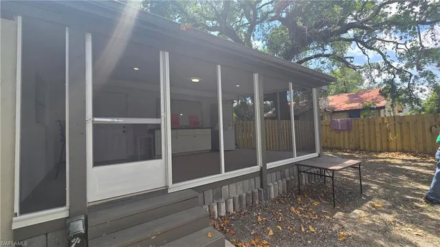 a view of backyard with table and chairs and a fire pit